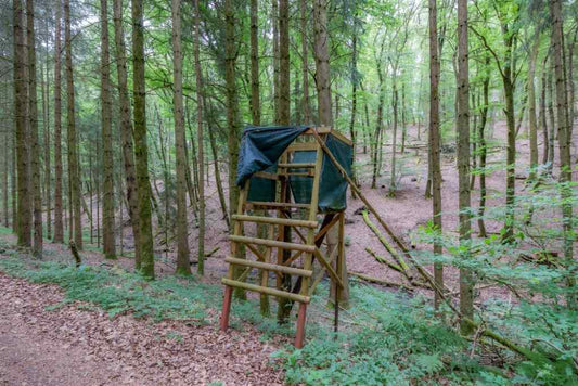 A DIY deer blind in a forest 